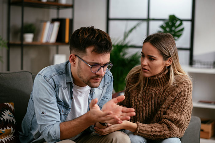 A woman listens intently as her boyfriend explains, revealing lies that built their relationship filled with fear.